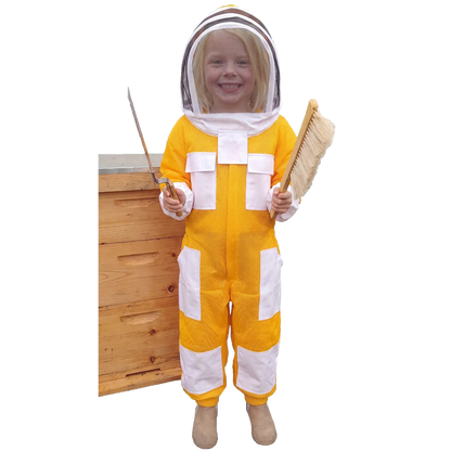 Child wearing a yellow kids beekeeping suit with protective veil beside a beehive